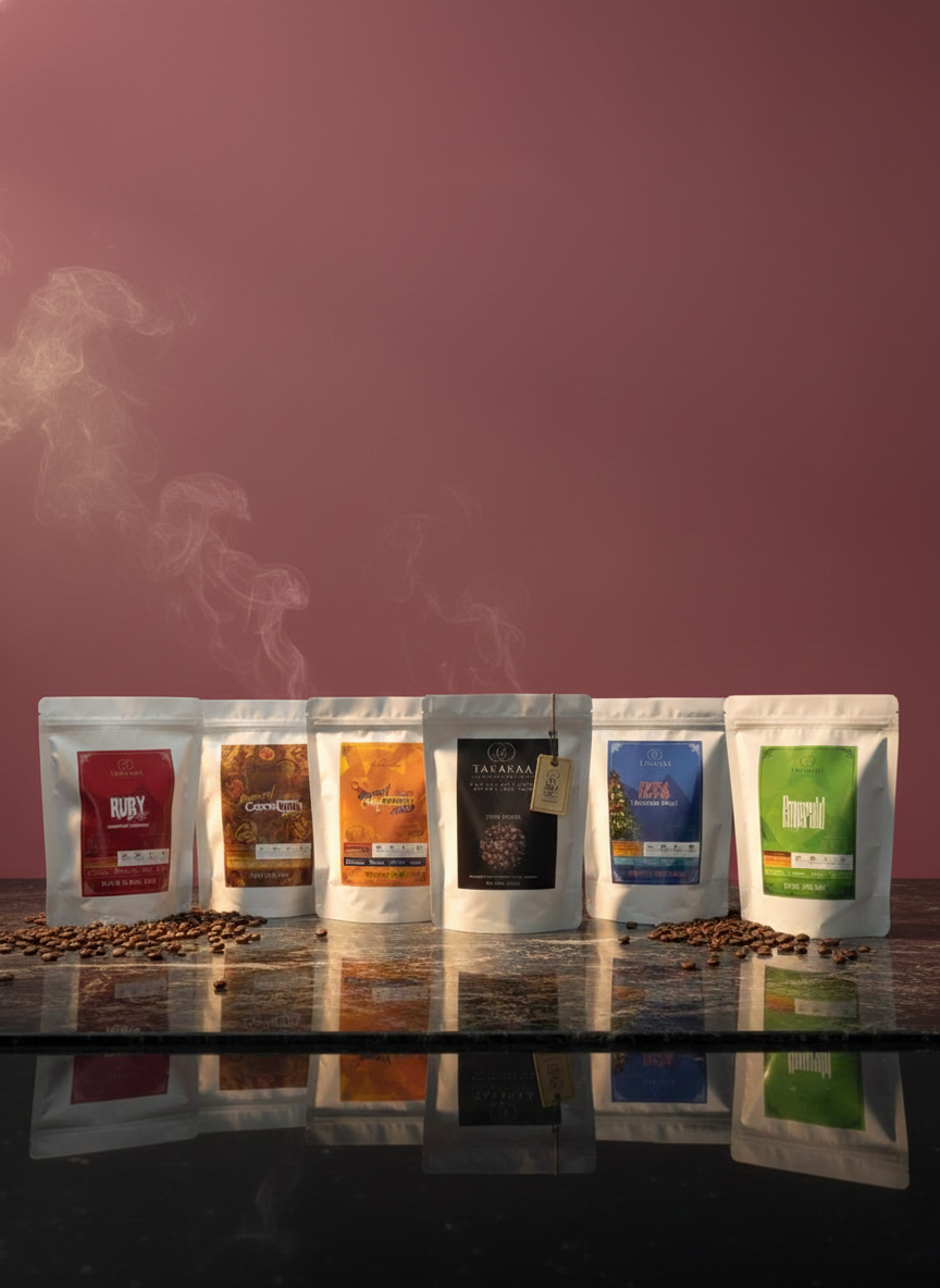 Six coffee bags with different labels on a reflective surface with a pinkish-brown background.